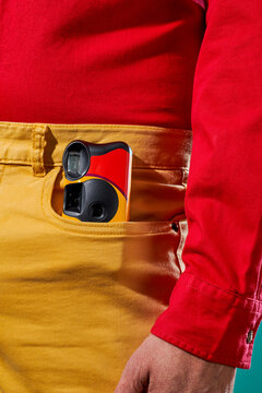man with a disposable camera in his pants pocket