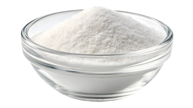 Clear glass bowl filled with salt isolated on white background.