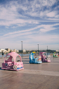 Colorful Kiddie Rides on a Waterfront Promenade in The Marina, Morocco