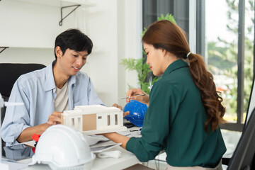 Obraz premium ESG and Sustainability. Young architects discussing building model in modern office.