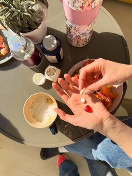  holding vitamins and supplements at breakfast