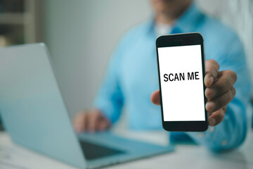 Businessman using smartphone with SCAN ME screen Cashless technology concept Scanning QR code with mobile smartphone Electronic wallet QR code payment