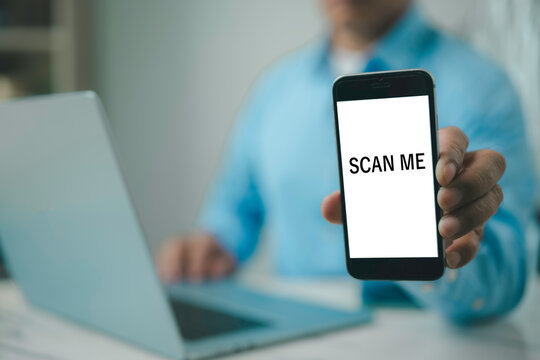 Businessman using smartphone with SCAN ME screen Cashless technology concept Scanning QR code with mobile smartphone Electronic wallet QR code payment