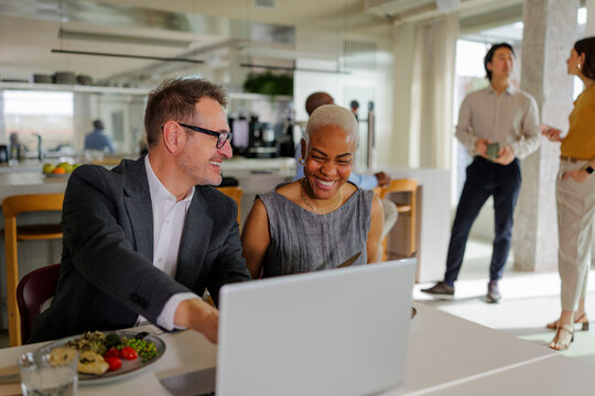 Formal business people working on laptop in modern office restaurant