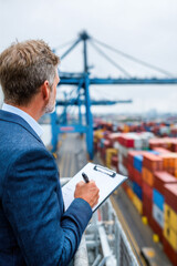 Businessman assessing risky and sanctioned cargo symbolizing customs law, import-export compliance, smuggling dangers, and financial consequences