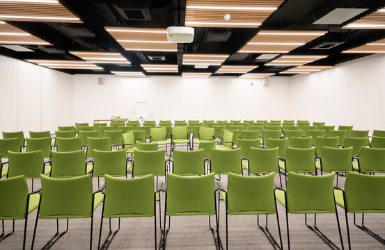 Conference Hall with Neatly Arranged Green Chairs

