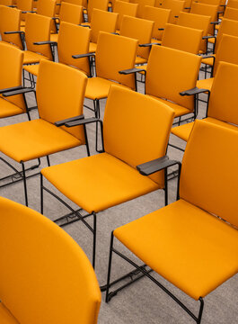 Rows Of Empty Orange Chairs Indoors