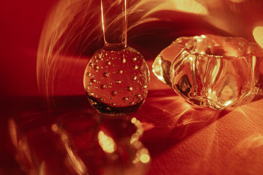Glass objects reflecting light on a vibrant red background