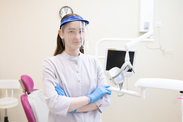 Portrait of male dentist in protective workwear at dental clinic