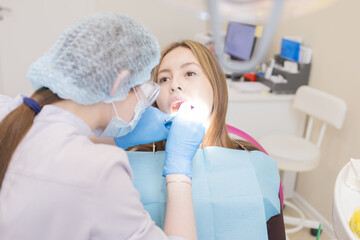 The dentist examines the patient's oral cavity. teeth