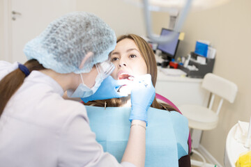 The dentist examines the patient's oral cavity. teeth