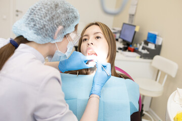 The dentist examines the patient's oral cavity. teeth
