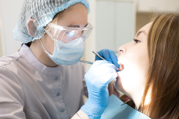 The dentist examines the patient's oral cavity. teeth