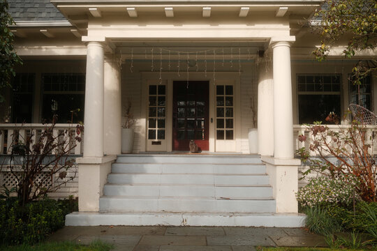 cat on front porch of house