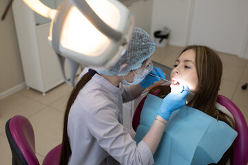 The dentist examines the patient's oral cavity. teeth