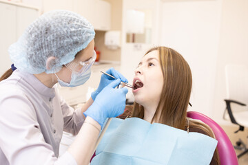 The dentist examines the patient's oral cavity. teeth