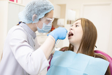 The dentist examines the patient's oral cavity. teeth