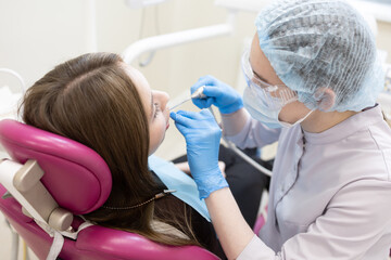 The dentist examines the patient's oral cavity. teeth