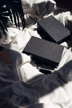 Black gift boxes on soft fabric