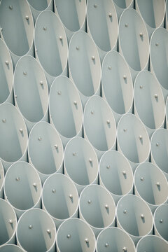 Repeating pattern of oval metal panels with bolts