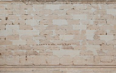 Smooth, weathered and cracked ancient wall made of stone blocks in Athens, Greece, viewed from the front. High resolution full frame textured background.