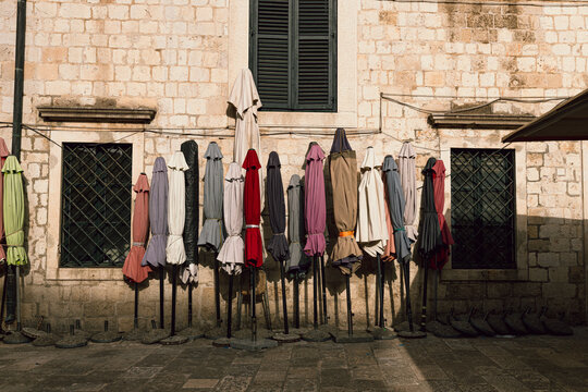 Fototapeta Colorful umbrellas lining a sunlit Dubrovnik street in the oldtown
