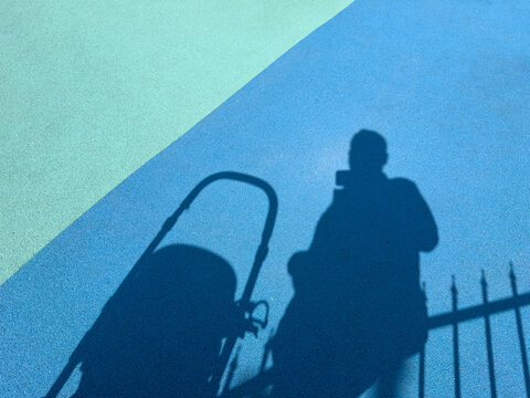 Shadow of a Person with a Stroller on a Live Rubber Floor