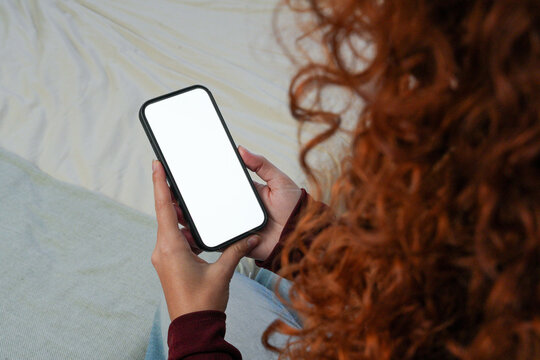 Woman using smartphone with blank screen