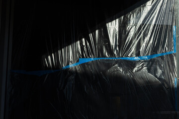 Plastic Covered Window With Tape Shadowy Background