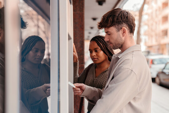 Young couple at ATM machine