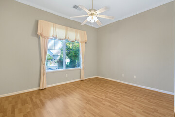 Bright and spacious empty residential rooms featuring natural light, neutral walls, and large windows. Ideal for real estate, interior design, and home staging themes.