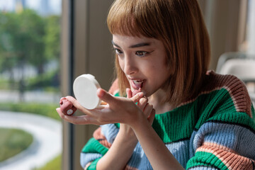 Young woman applying makeup