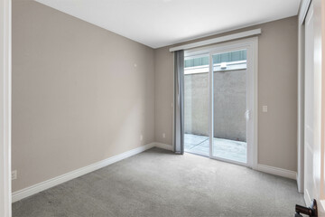 Bright and spacious empty residential rooms featuring natural light, neutral walls, and large windows. Ideal for real estate, interior design, and home staging themes.