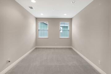 Bright and spacious empty residential rooms featuring natural light, neutral walls, and large windows. Ideal for real estate, interior design, and home staging themes.
