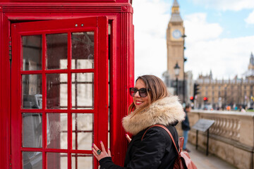 Woman near a Telephone booth in London