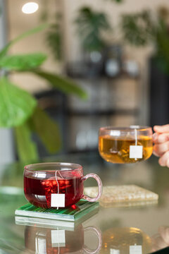 Sharing a cup of yellow tea with a vibrant background at home
