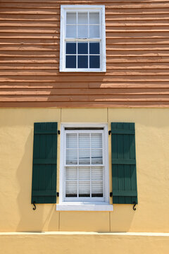 Fototapeta Yellow And Brown House With Green Shutters