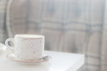 a cup of coffee in the interior of a cozy cafe for breakfast