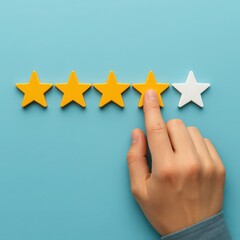 Customer service concept hand selecting a rating of four out of five stars on a light blue background