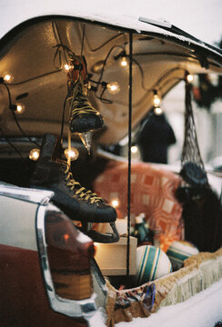 Fototapeta Vintage Car Trunk with Ice Skates and Lights 