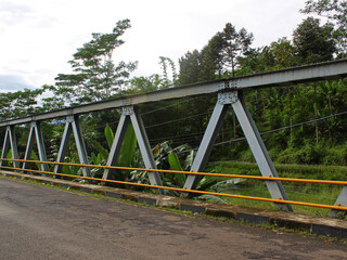 Close-up of bridge frame in the morning with forest in the background. 