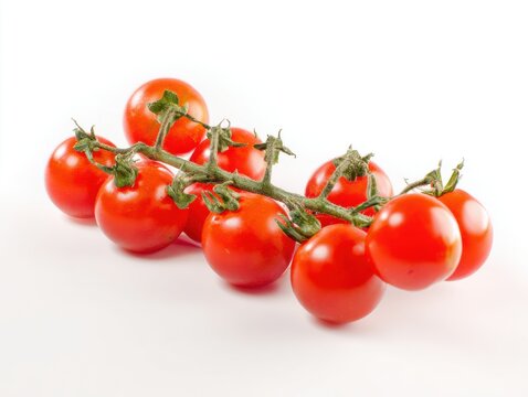 Bunch of red cherry tomatoes on vine isolated on white background