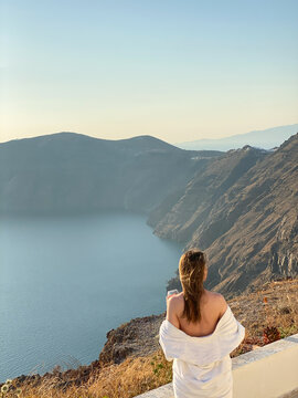 Woman in Towel Enjoying Mountain View with Drink
