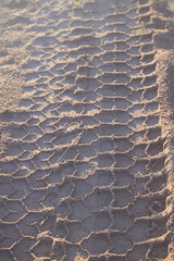 tire tread marks on a clay road, abstract texture background