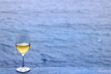 a glass of white wine on the background of the sea relaxing by the sea with wine