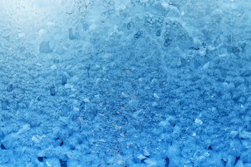 winter blue background ice frozen texture on the window