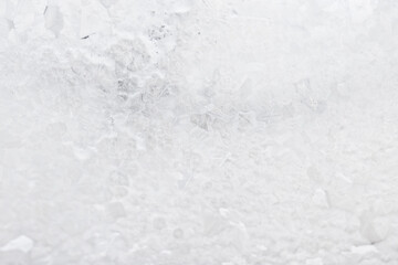 white winter background, frosty patterns on glass, abstract backdrop of ice and snow crystals in a blur