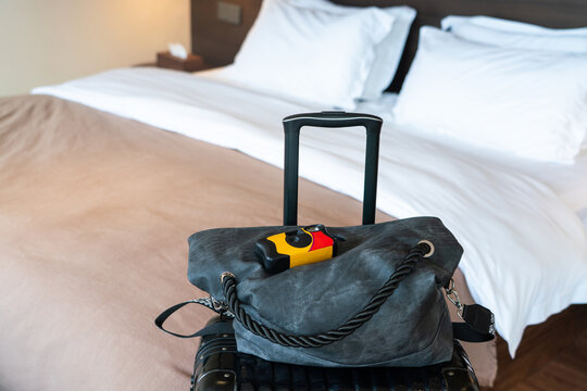 Luggage and disposable camera on hotel bed