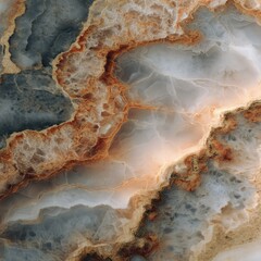 Close-up view of a natural stone, exhibiting a rich blend of grey, white, and ochre hues.  Veins and patterns create a visually captivating texture