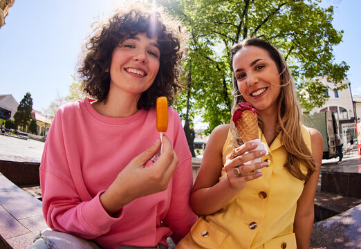 Women are enjoying ice creams outside